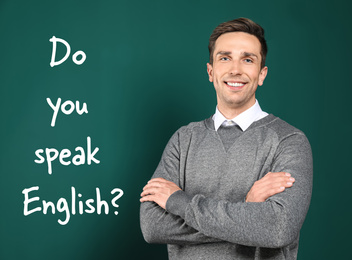 Image of Young teacher near chalkboard with question DO YOU SPEAK ENGLISH