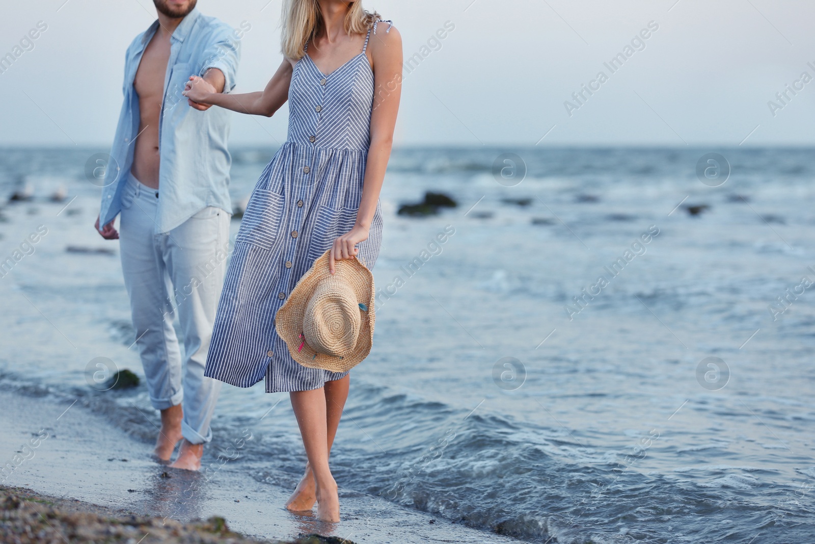 Photo of Young couple spending time together on beach
