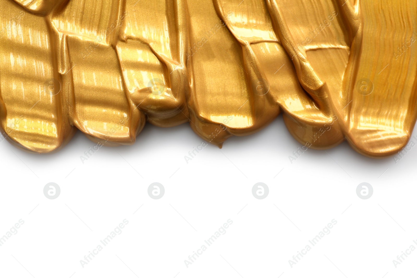 Photo of Strokes of gold paint isolated on white, top view