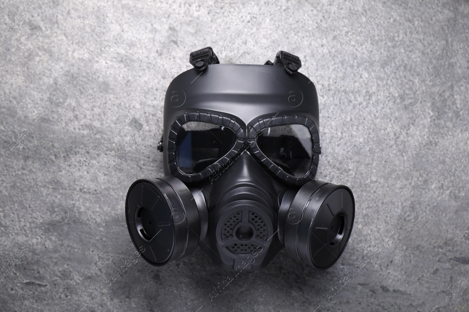 Photo of One gas mask on grey textured background, top view