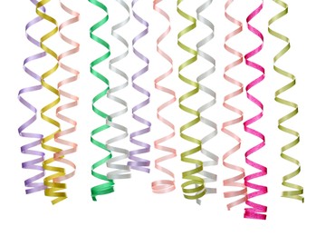 Photo of Many colorful serpentine streamers on white background