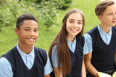 Photo of Teenage students in stylish school uniform outdoors