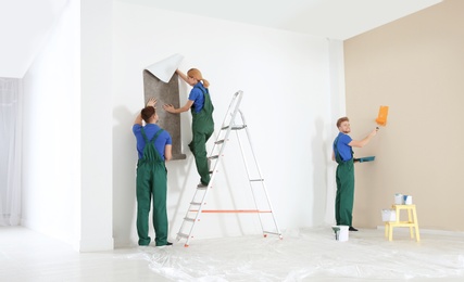 Professional decorators working indoors. Home repair service