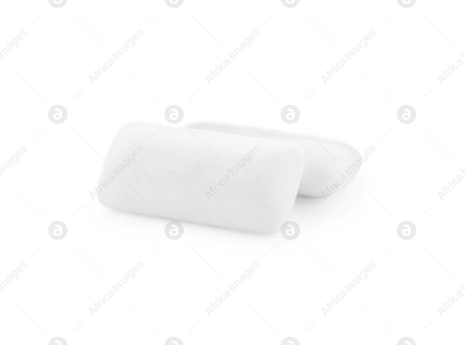 Photo of Two pieces of chewing gum on white background