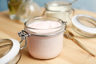 Photo of Jar with yummy yogurt on wooden table