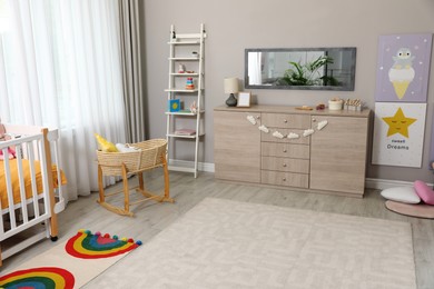 Photo of Beautiful baby room interior with stylish furniture