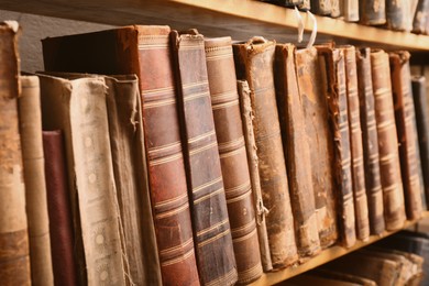 Collection of old books on shelf in library, closeup