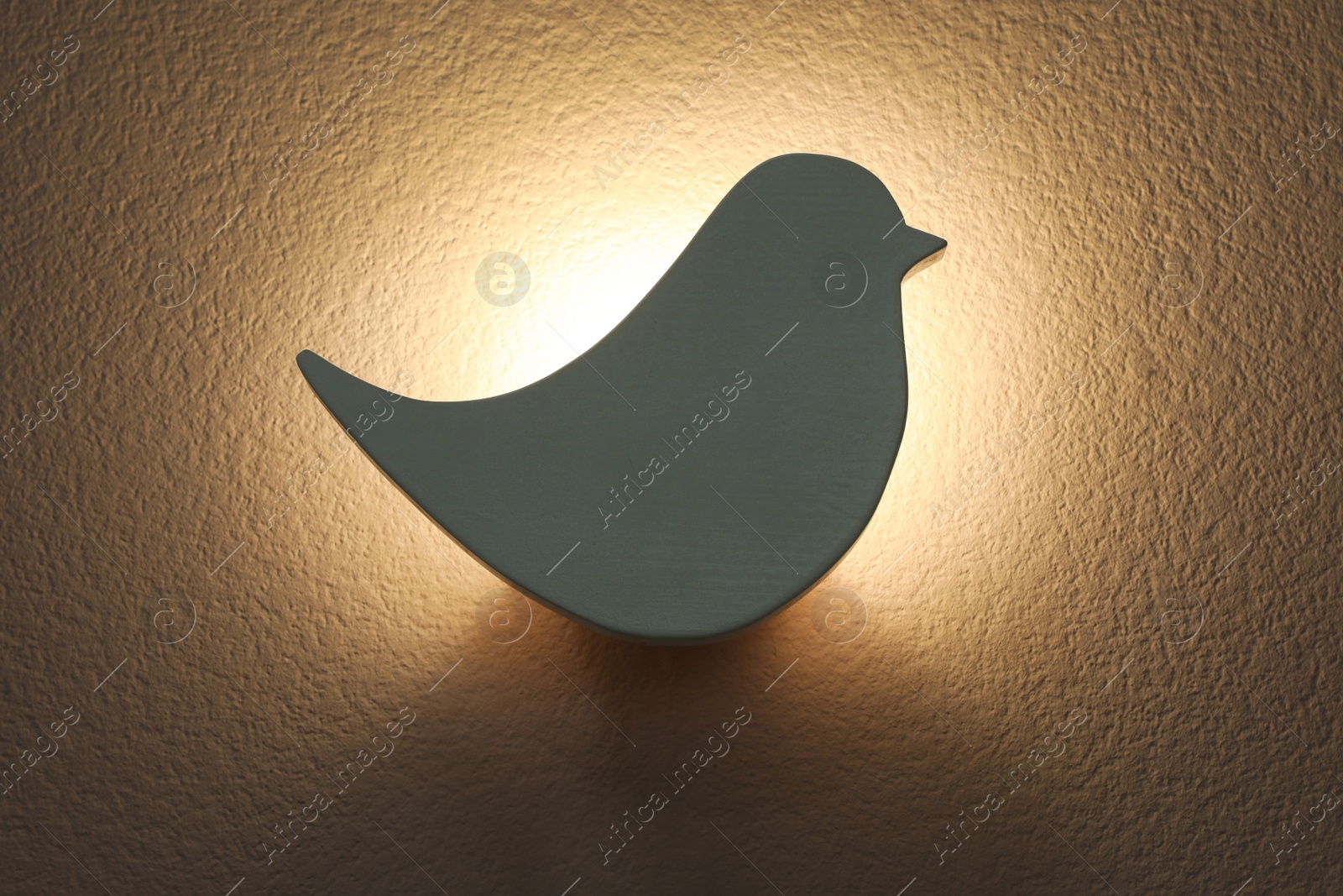 Photo of Bird shaped glowing night lamp on wall