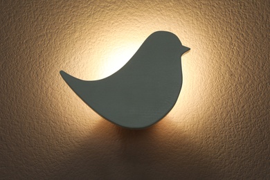 Photo of Bird shaped glowing night lamp on wall