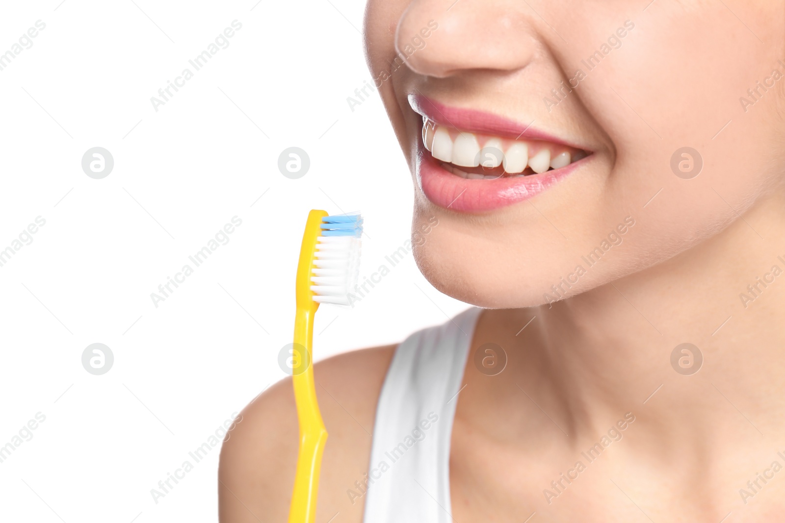 Photo of Young woman brushing her teeth on white background, closeup