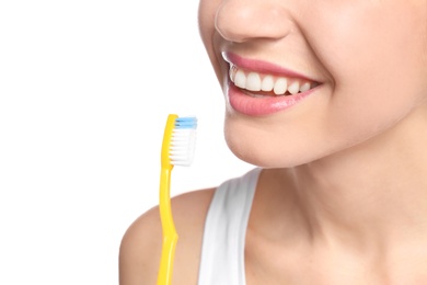 Photo of Young woman brushing her teeth on white background, closeup