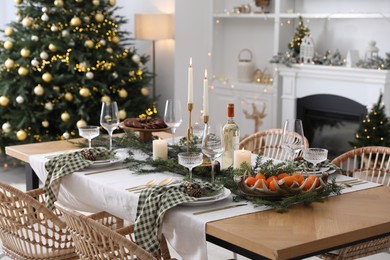 Christmas table setting with festive decor and dishware in living room