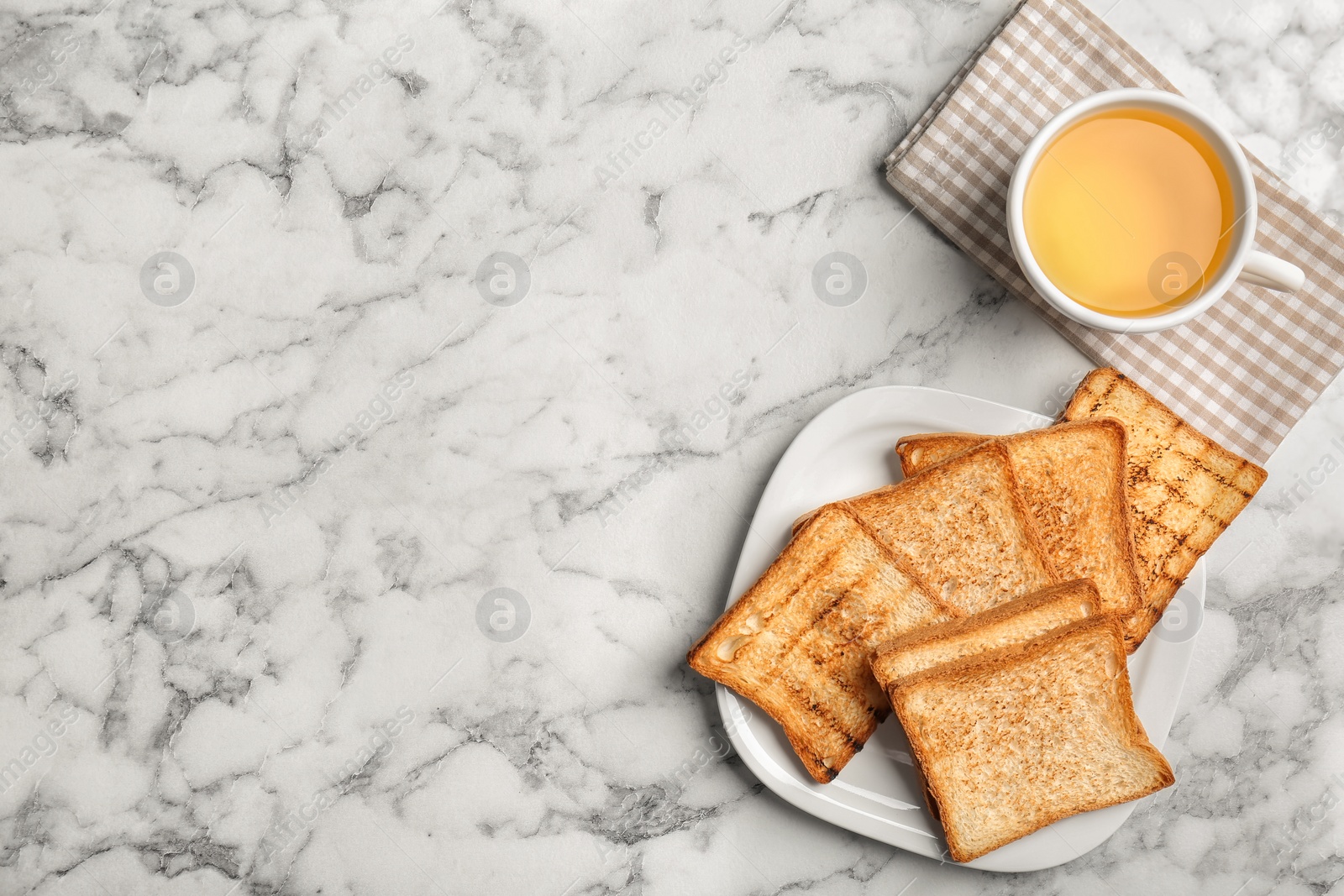 Photo of Plate with toasted bread and cup of tea on light background, top view