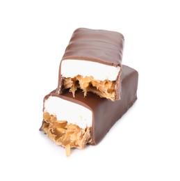 Pieces of tasty chocolate bars with nougat and nuts on white background