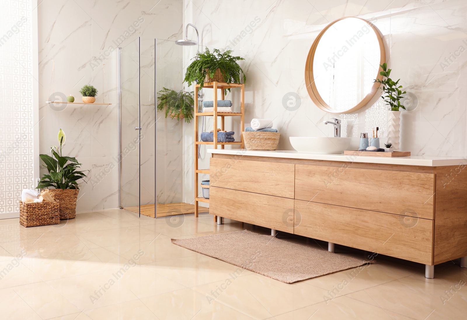 Photo of Stylish bathroom interior with countertop, shower stall and houseplants. Design idea