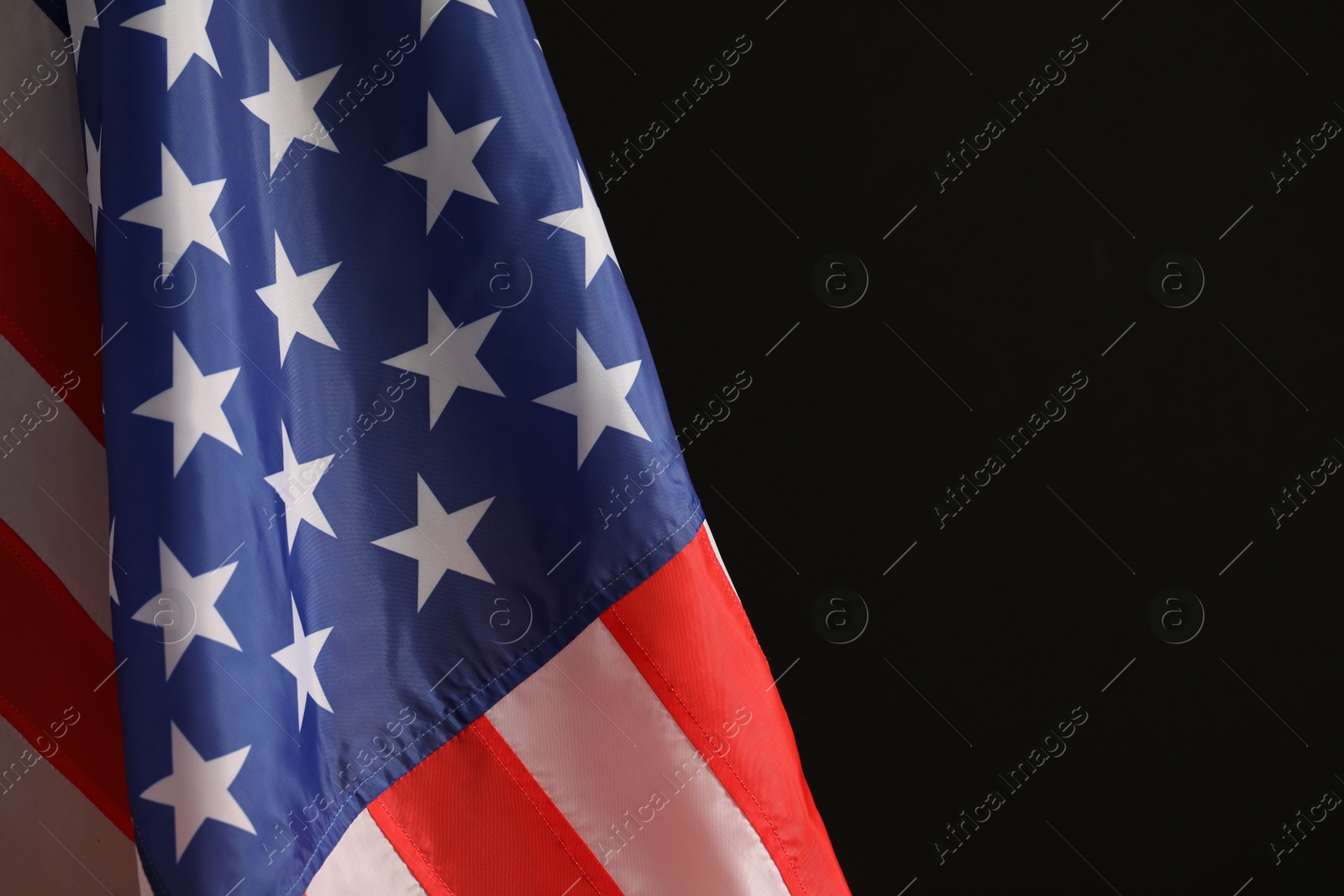 Photo of National flag of America on black background, space for text. Memorial day celebration