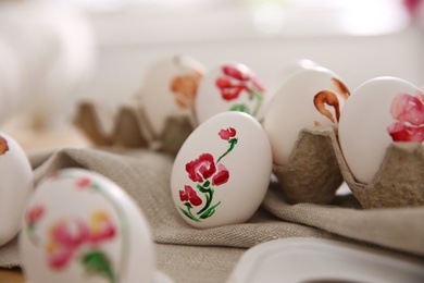 Photo of Beautifully painted Easter eggs on table indoors