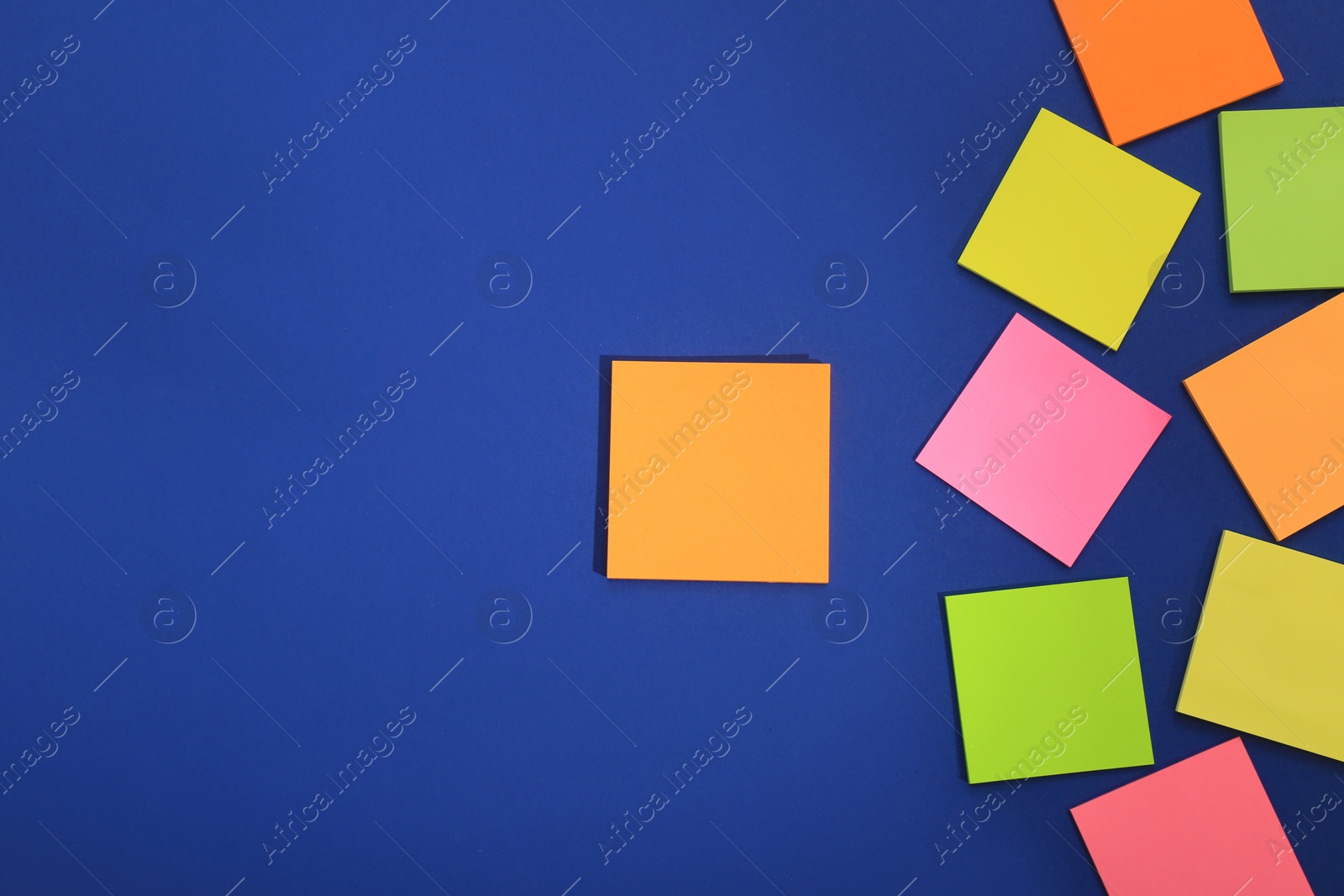 Photo of Many colorful stickers on blue background, flat lay. Space for text