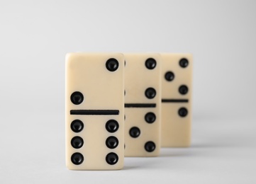 Photo of Row of domino tiles on white background, closeup