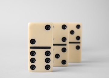 Row of domino tiles on white background, closeup