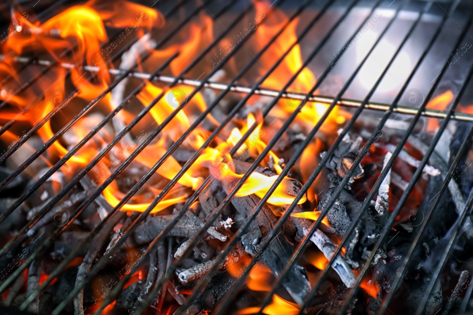 Photo of New modern barbecue grill with coals, closeup