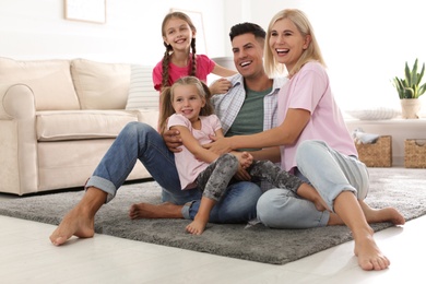 Photo of Portrait of happy family on floor at home