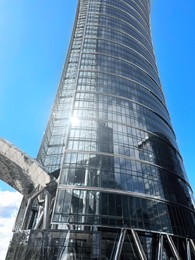 Low angle view of modern office building on sunny day