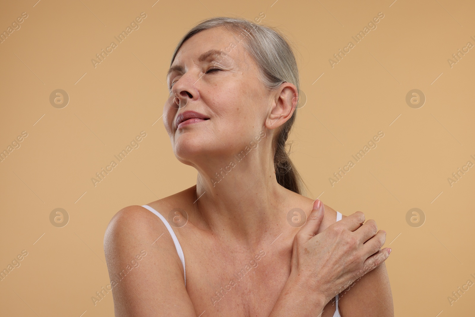 Photo of Beautiful woman with healthy skin on beige background