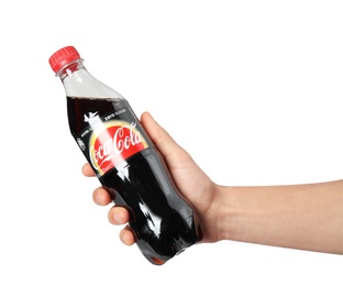 MYKOLAIV, UKRAINE - NOVEMBER 15, 2018: Man holding bottle of Coca Cola on white background, closeup