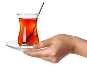 Photo of Woman holding glass of Turkish tea on white background, closeup