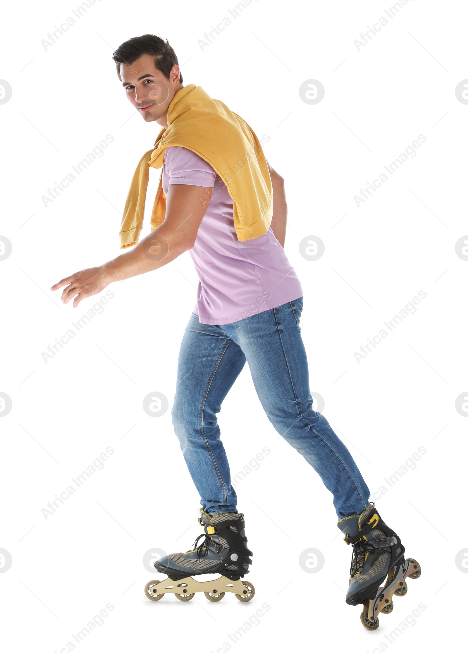 Photo of Handsome young man with inline roller skates on white background