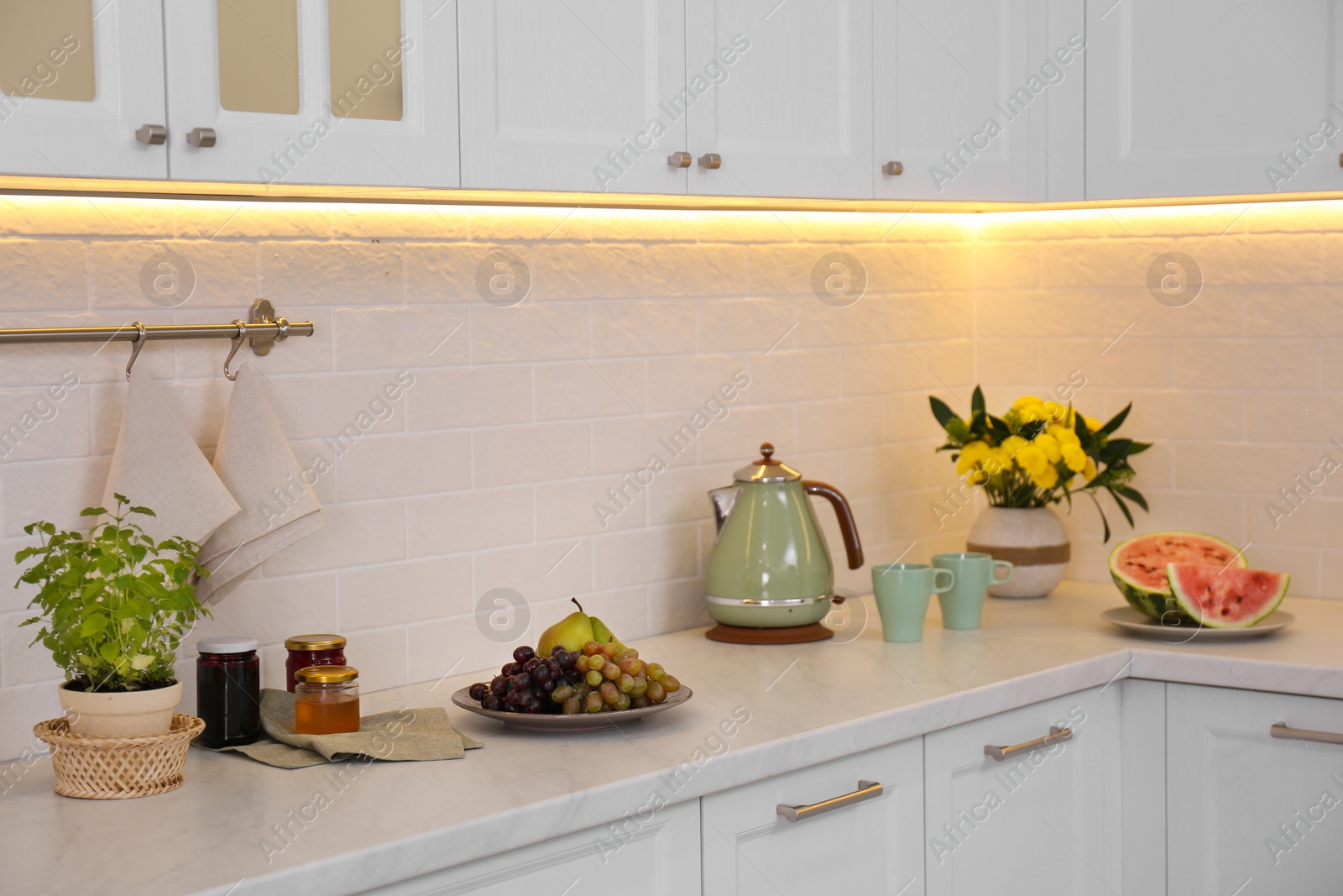 Photo of Modern kitchen interior with products on counter