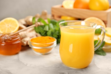 Photo of Immunity boosting drink and ingredients on table, closeup. Space for text