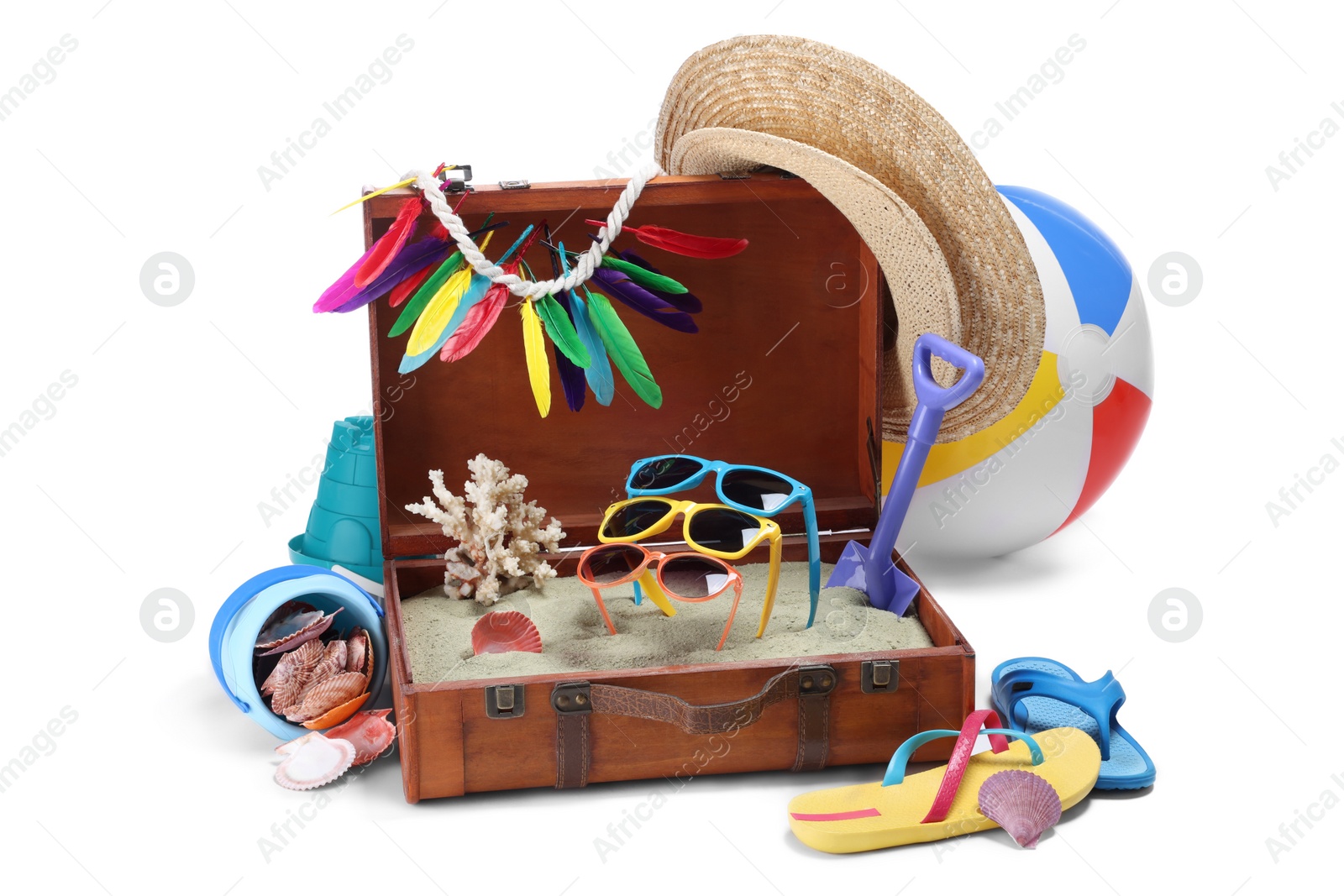 Photo of Open suitcase with clothes, beach accessories and shoes isolated on white. Summer vacation