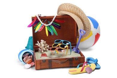 Photo of Open suitcase with clothes, beach accessories and shoes isolated on white. Summer vacation