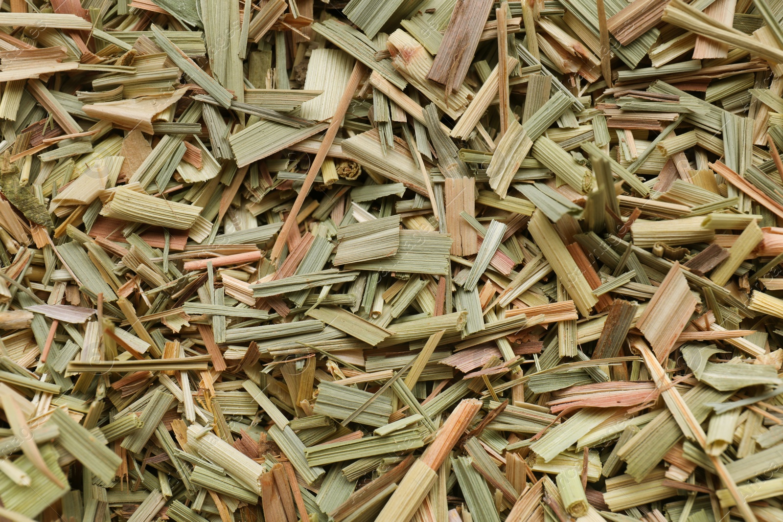 Photo of Aromatic dried lemongrass as background, top view