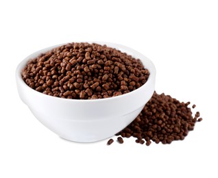Bowl with buckwheat tea granules on white background