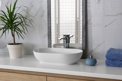 Photo of Modern mirror and vessel sink in stylish bathroom