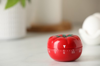 Photo of Kitchen timer in shape of tomato on white table. Space for text