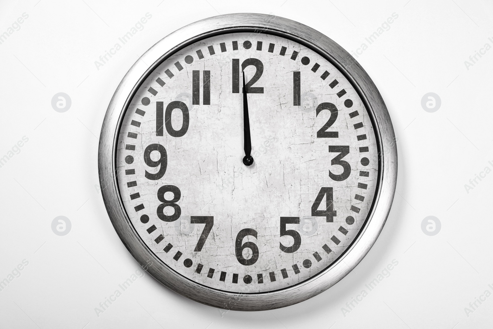 Photo of Stylish analog clock hanging on white wall