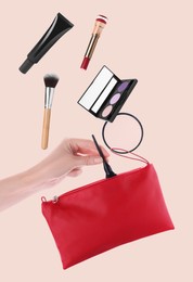 Makeup products. Woman taking eyeliner from cosmetic bag on beige background, closeup