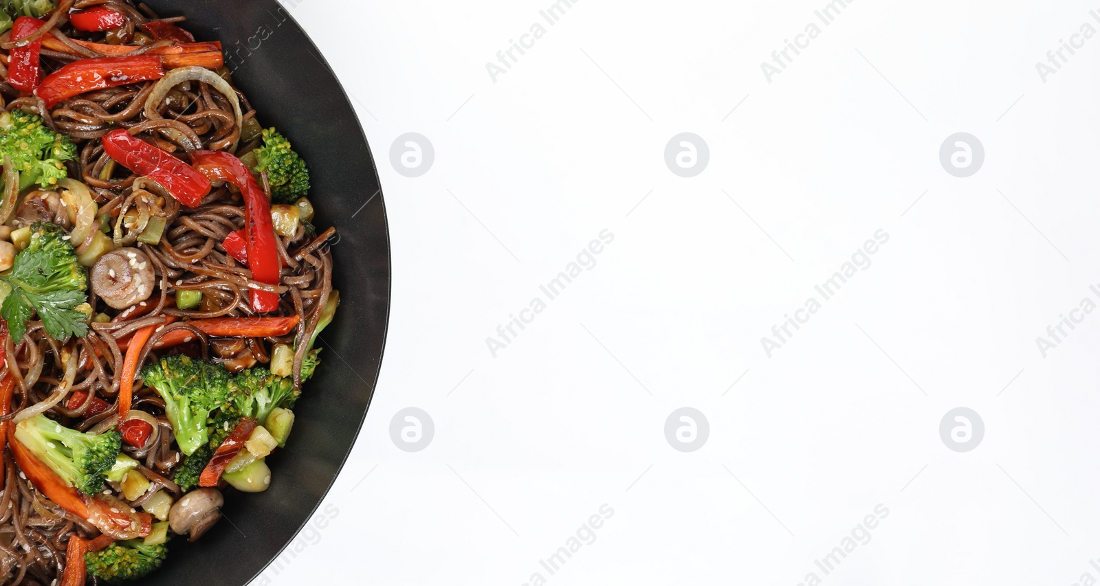 Photo of Stir-fry. Tasty noodles with meat and vegetables in wok on white background, top view. Space for text