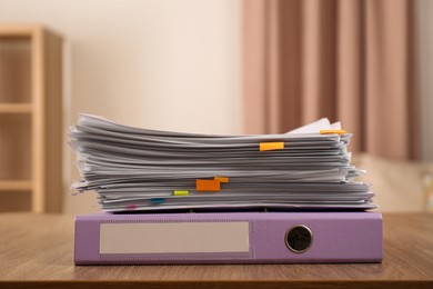 Stack of documents and office folder on wooden table indoors