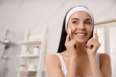 Photo of Woman using silkworm cocoons in skin care routine at home