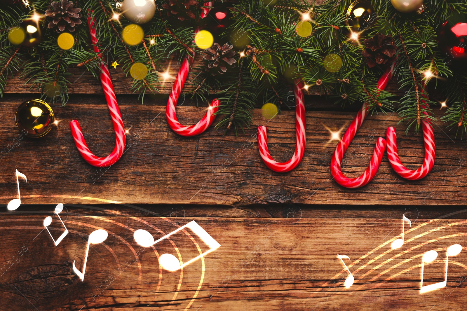 Image of Music notes and wooden table with fir branches and festive decor, top view. Christmas and New Year melody