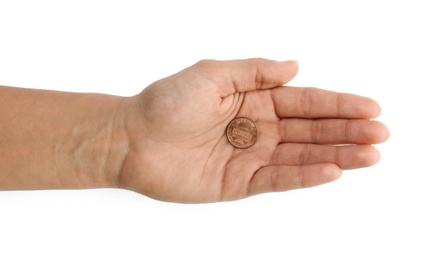 Photo of Young man holding coin on white background, top view