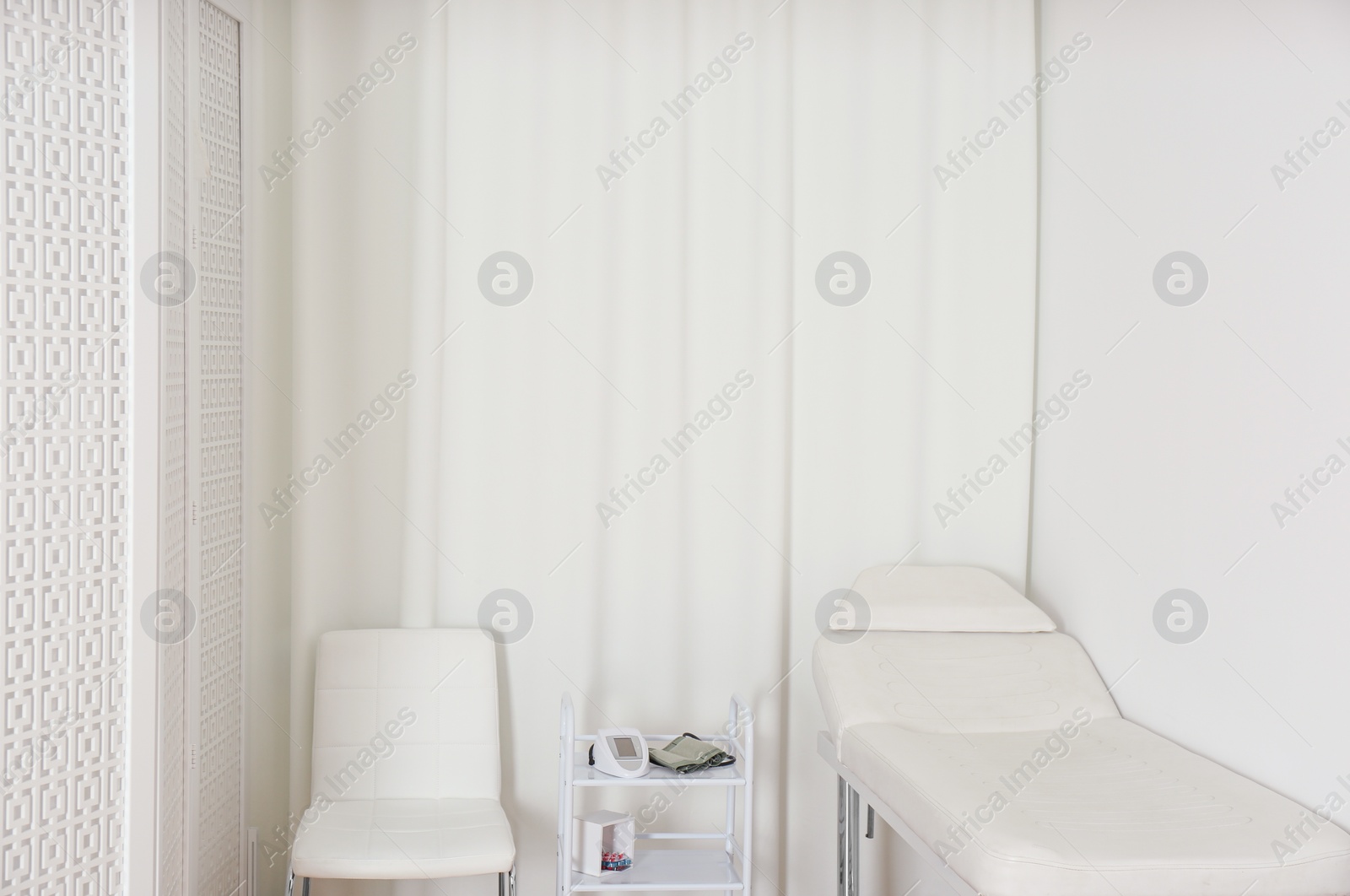 Photo of Empty examination couch in modern medical office