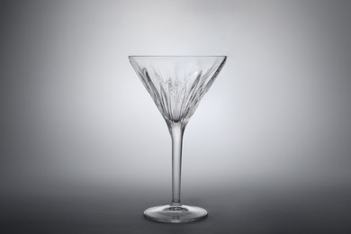 Photo of Elegant empty martini glass on grey background