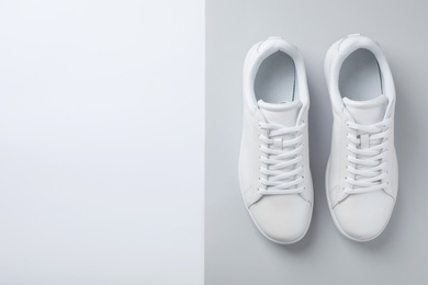 Photo of Pair of trendy sneakers on light background, flat lay. Space for text