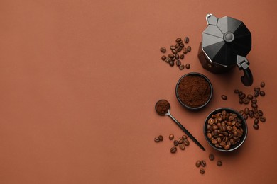 Photo of Flat lay composition with coffee grounds and roasted beans on brown background, space for text